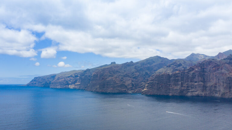 The Los Gigantes cliffs under a blue sky, seen from above the ocean