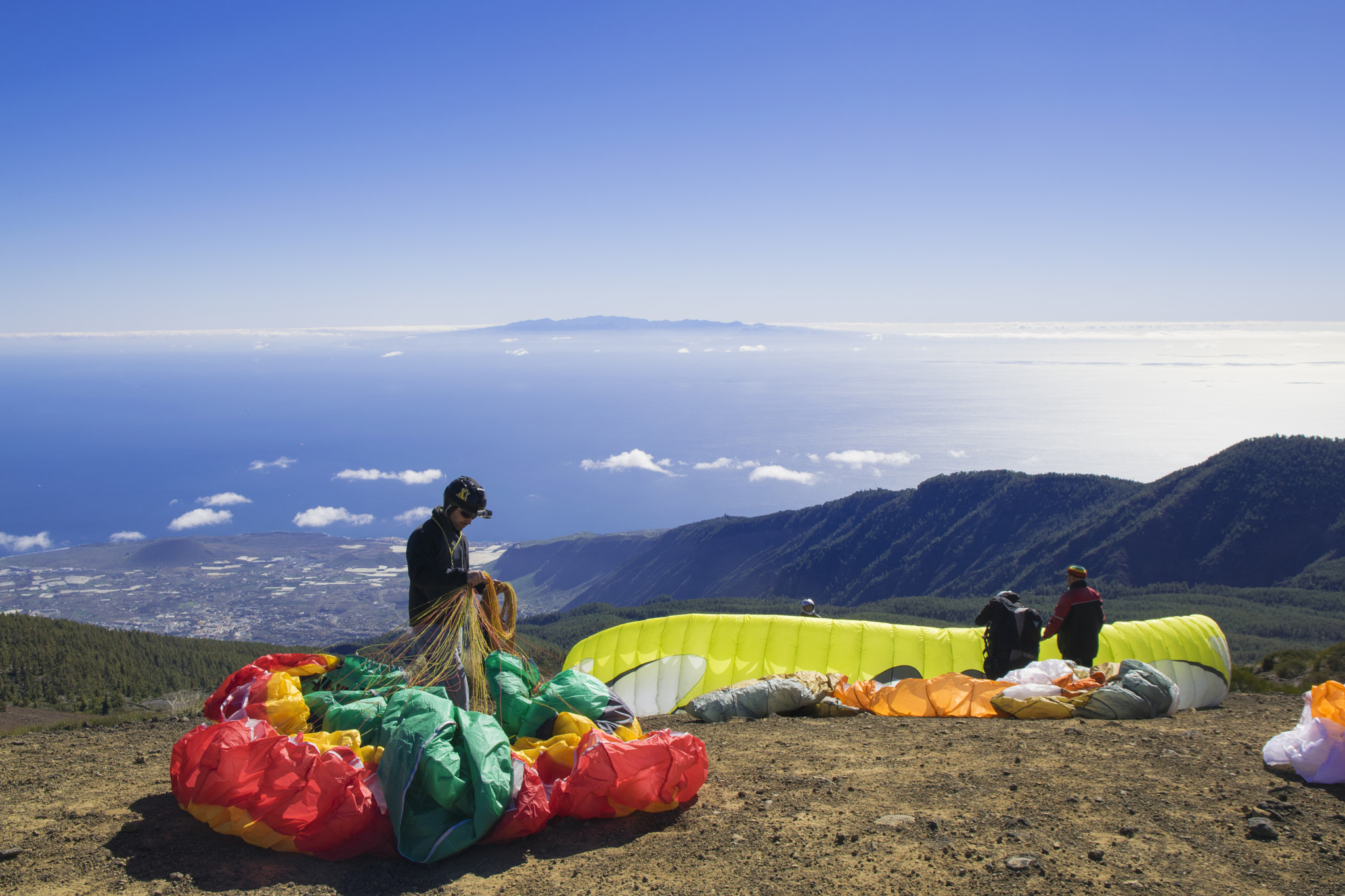 Paragliders preparing their wings above the Tenerife coast