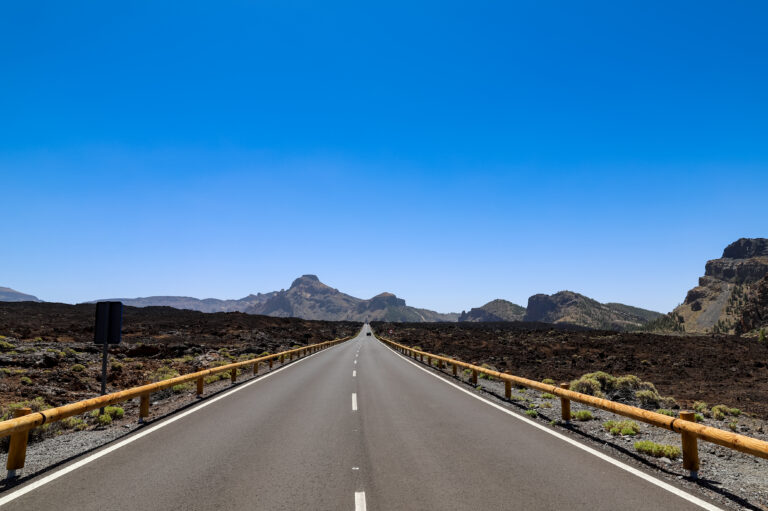 The TF-38 road climbing straight through black lava fields in Teide National Park