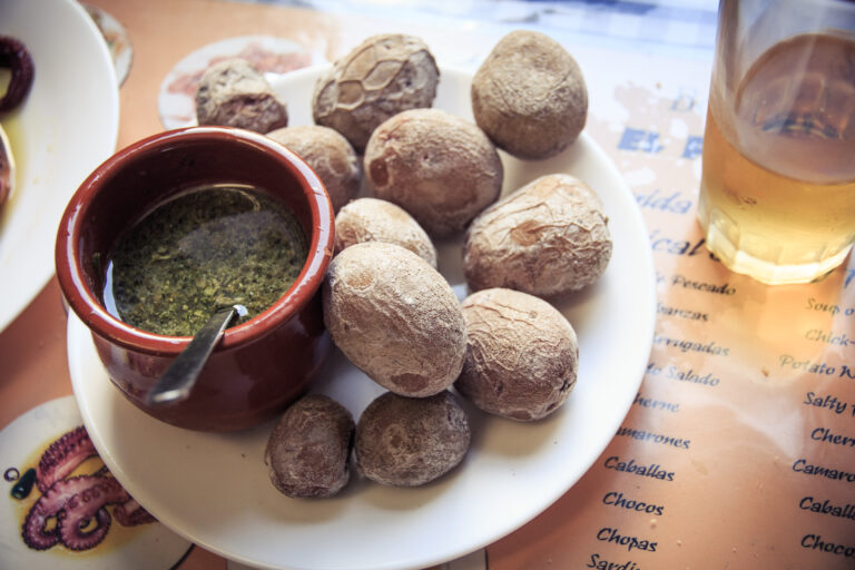 Papas arrugadas with green mojo in a Canarian restaurant